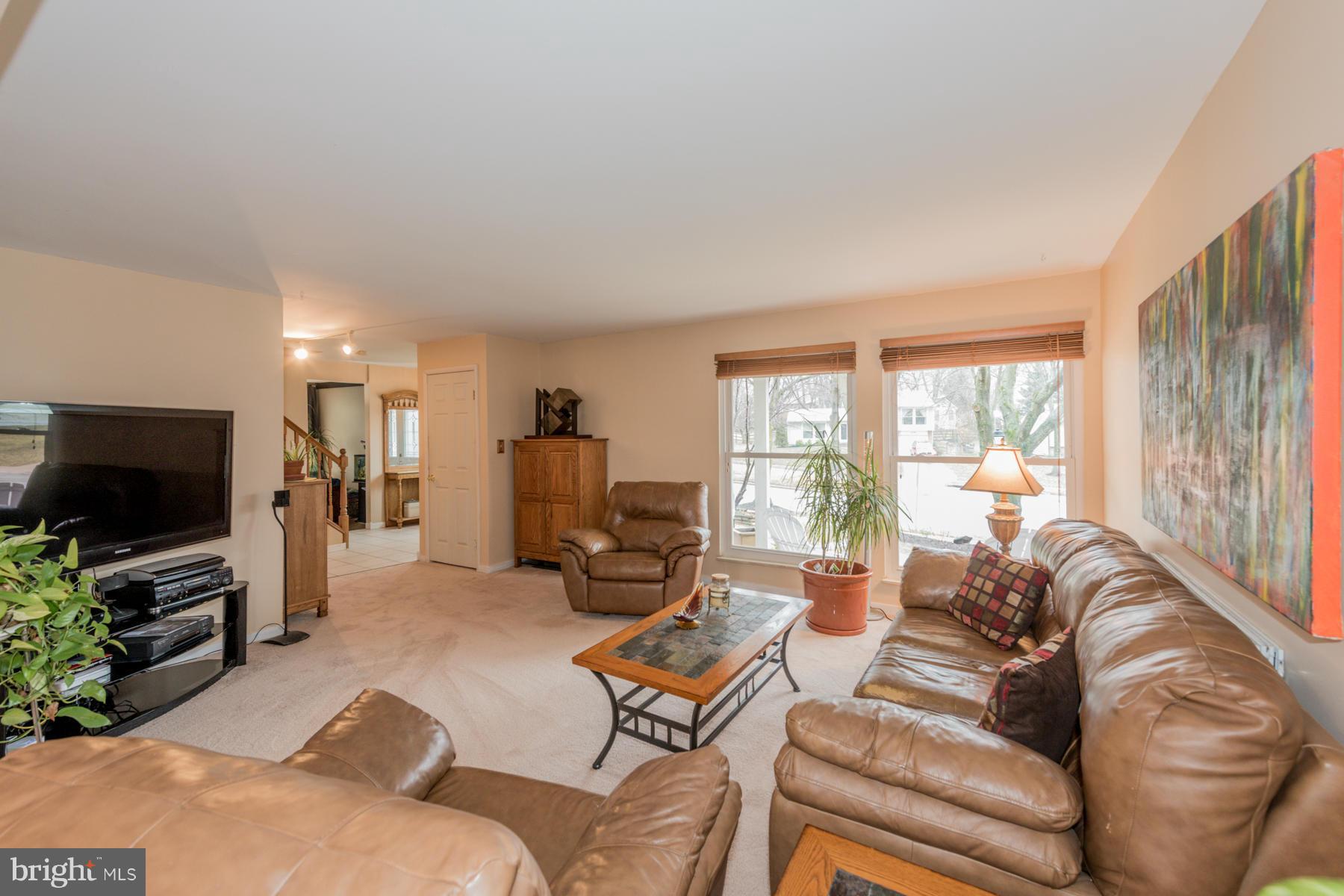 6166 Stevens Forest Road Columbia, MD 21045 - Photo 6 of 28 a living room with furniture and a flat screen tv
