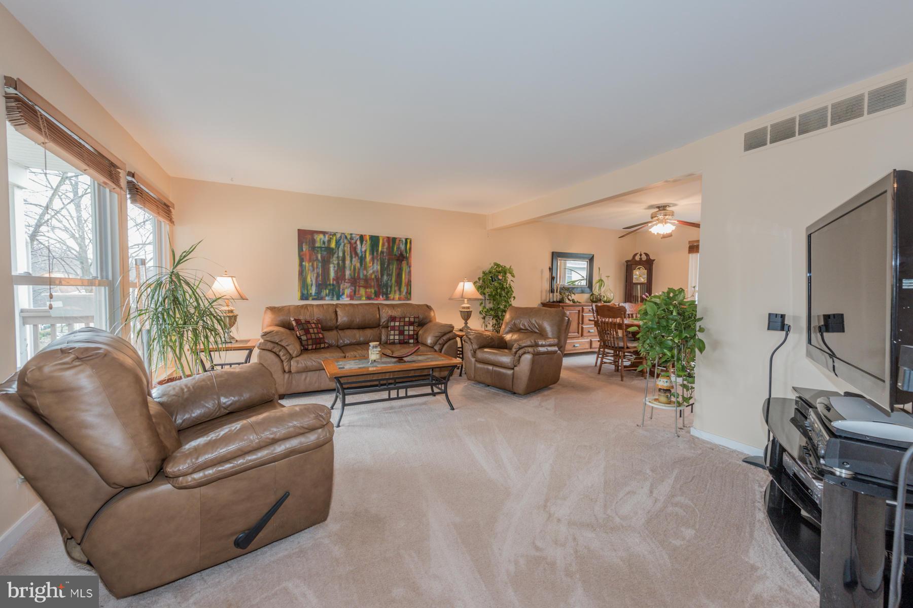 6166 Stevens Forest Road Columbia, MD 21045 - Photo 7 of 28 a living room with furniture and a flat screen tv