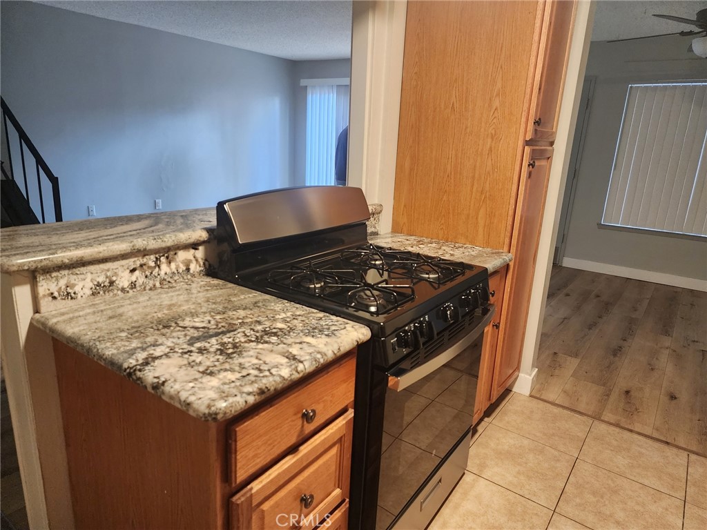 a kitchen with granite countertop a stove and a sink