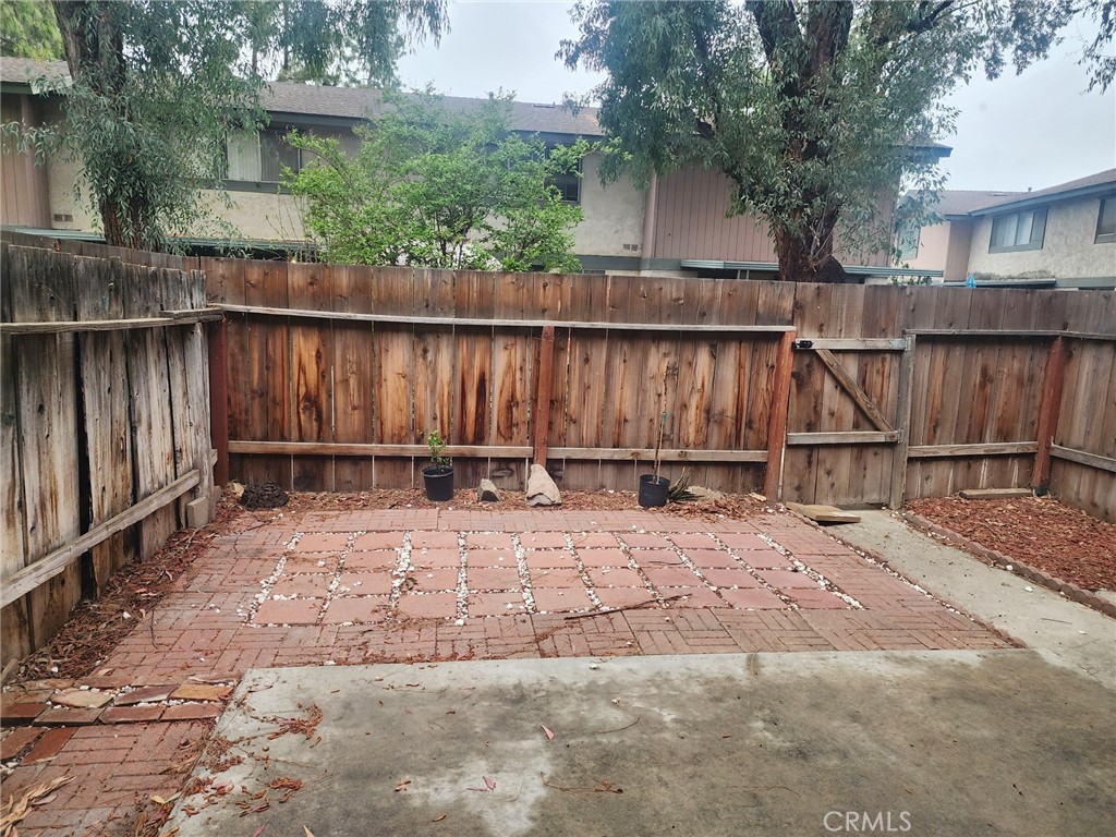 4877 Jackson Street, Unit C Riverside, CA 92503 - Photo 12 of 12 a view of backyard with small cabin and wooden fence