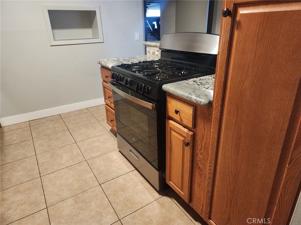 4877 Jackson Street, Unit C Riverside, CA 92503 - Photo 2 of 12 a kitchen with a stove and a refrigerator