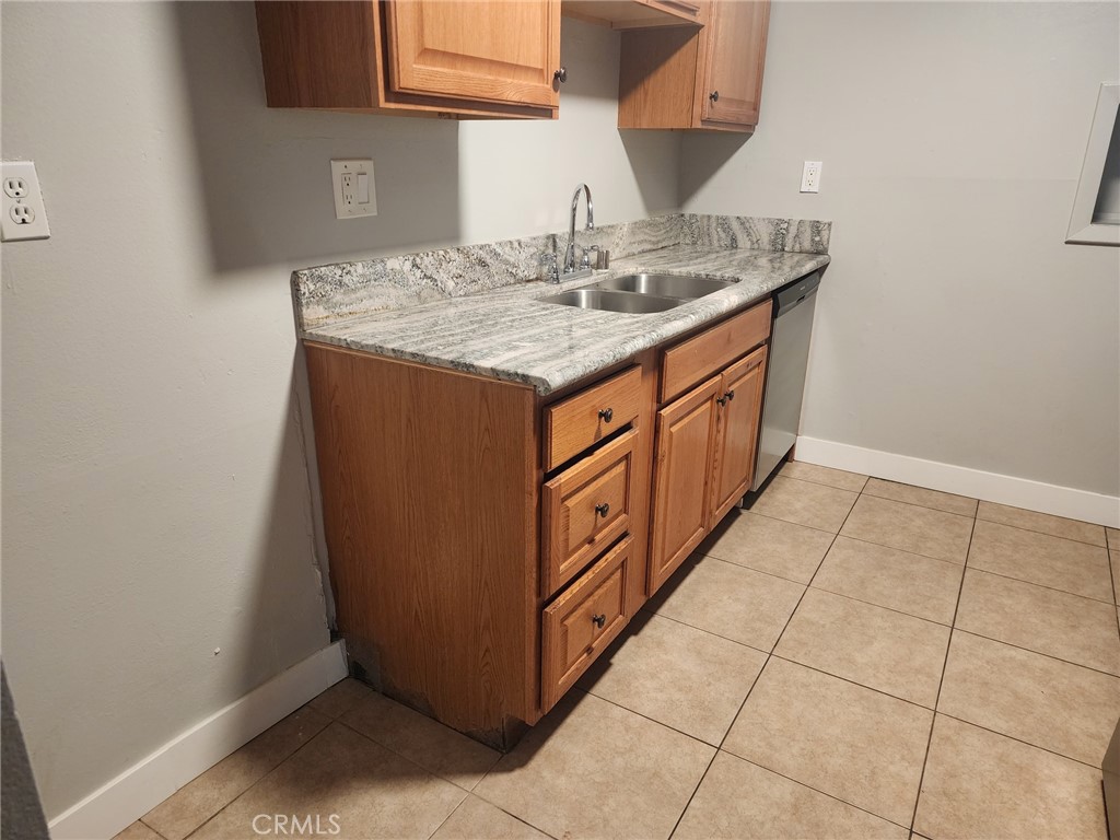 4877 Jackson Street, Unit C Riverside, CA 92503 - Photo 3 of 12 a kitchen with stainless steel appliances granite countertop a sink and dishwasher