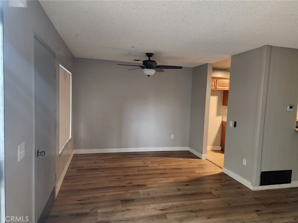 4877 Jackson Street, Unit C Riverside, CA 92503 - Photo 6 of 12 wooden floor in an empty room with a window