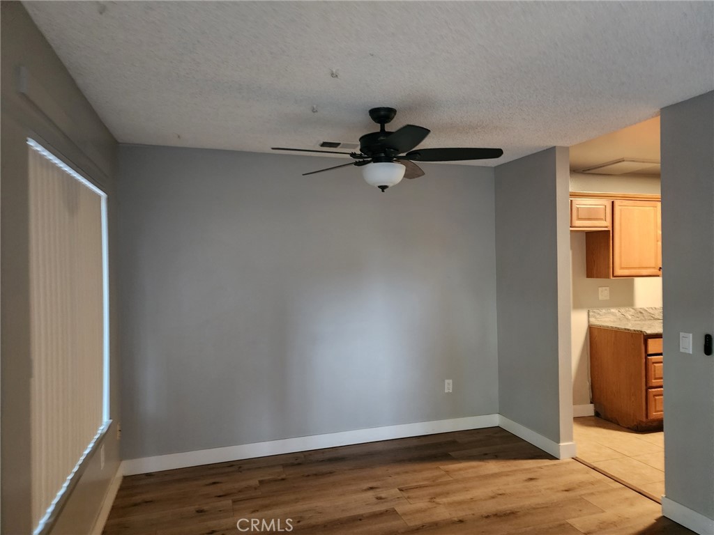 4877 Jackson Street, Unit C Riverside, CA 92503 - Photo 7 of 12 a view of empty room with wooden floor and fan