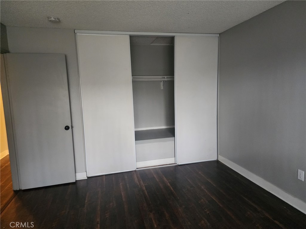4877 Jackson Street, Unit C Riverside, CA 92503 - Photo 8 of 12 a view of an empty room with wooden floor