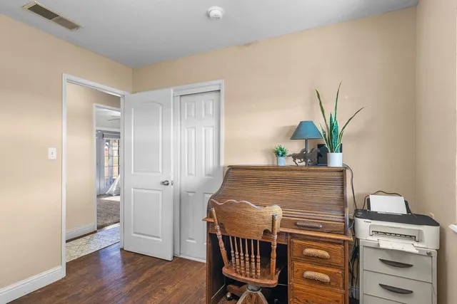 a dining room with furniture and wooden floor