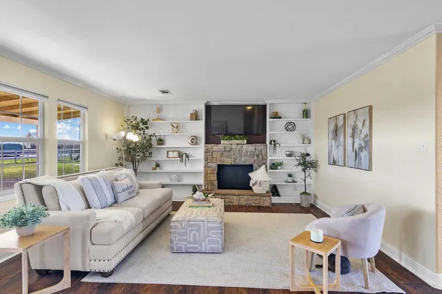 a living room with furniture a fireplace and a flat screen tv