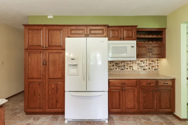 a white refrigerator freezer sitting inside of a kitchen