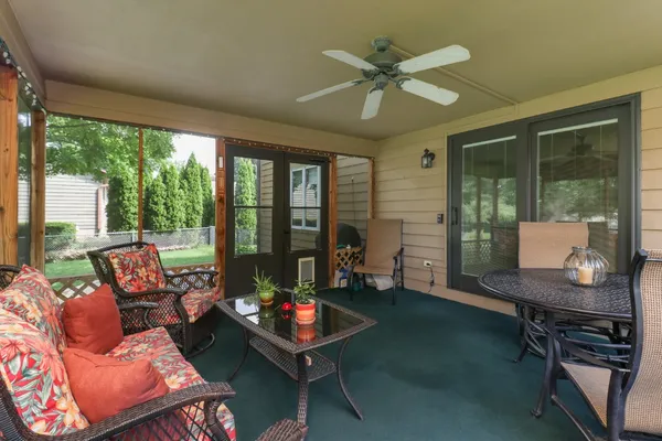 a living room with furniture and a floor to ceiling window