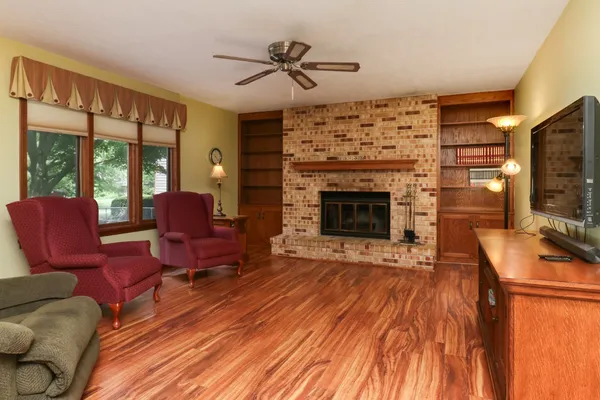 a living room with furniture fireplace and flat screen tv