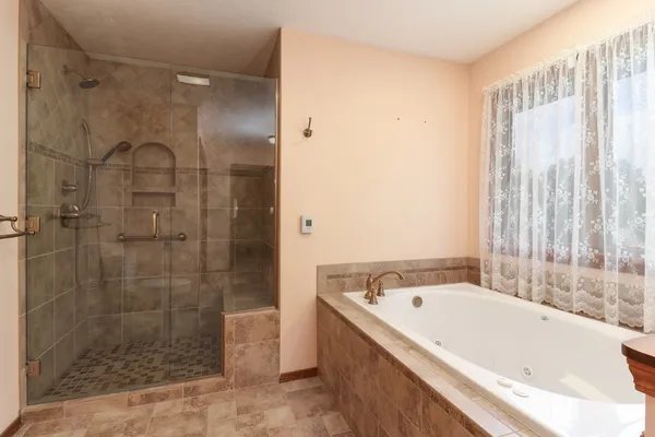 a en suite bathroom with a double vanity sink and a mirror