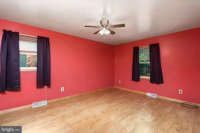 a view of a livingroom with a ceiling fan and window