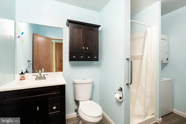 a bathroom with a sink vanity mirror and toilet