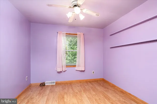 a view of a bedroom with a bed and a window