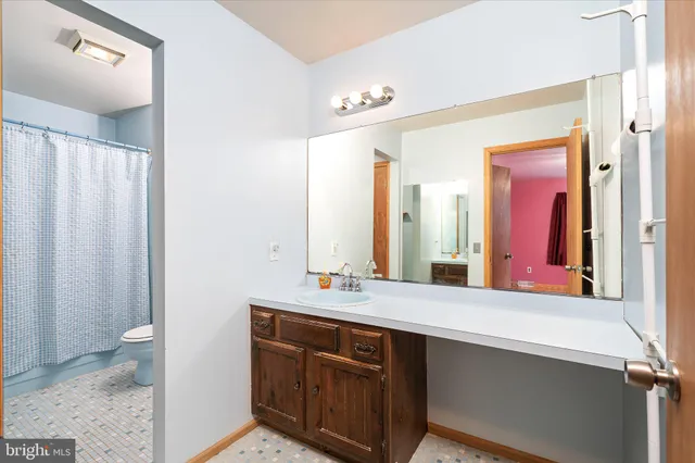 a white toilet sitting next to a bath tub