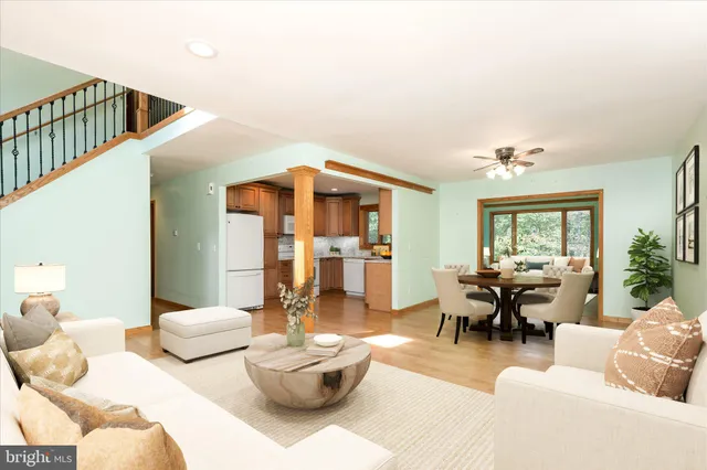 a living room with furniture and a chandelier