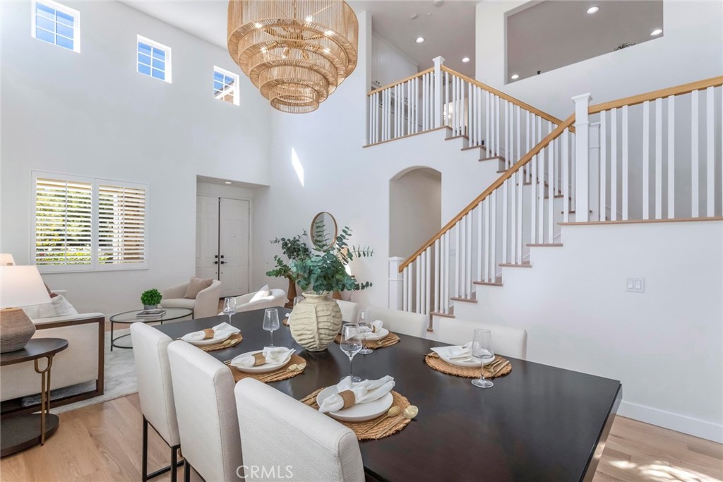 26413 Ocasey Place Stevenson Ranch, CA 91381 - Photo 16 of 75 a dining room with furniture a potted plant and wooden floor