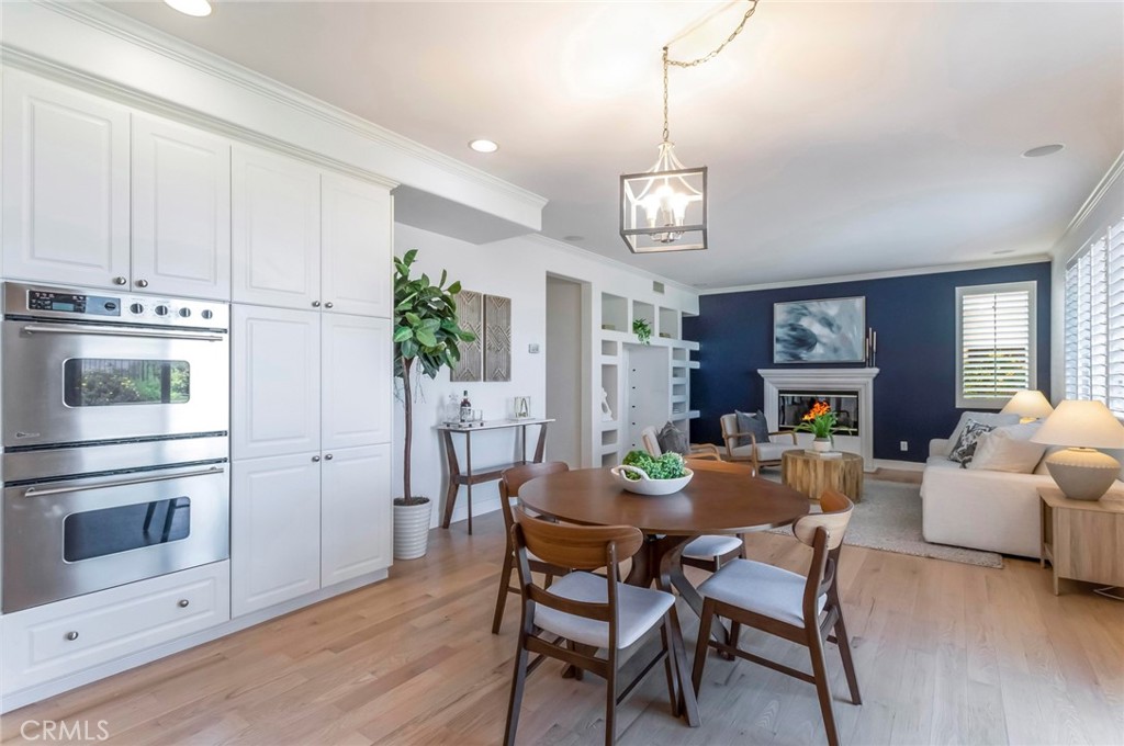 26413 Ocasey Place Stevenson Ranch, CA 91381 - Photo 22 of 75 a view of a dining room with furniture a chandelier and wooden floor