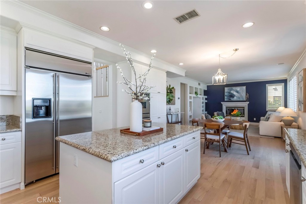 26413 Ocasey Place Stevenson Ranch, CA 91381 - Photo 26 of 75 a living room with stainless steel appliances kitchen island granite countertop furniture wooden floor and a view of kitchen