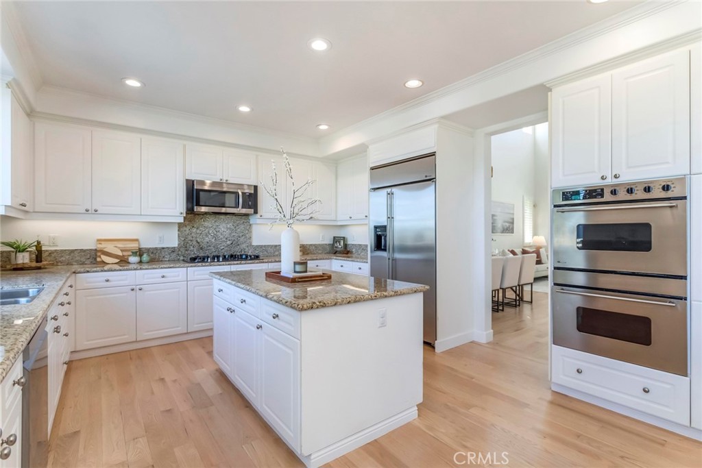 26413 Ocasey Place Stevenson Ranch, CA 91381 - Photo 28 of 75 a kitchen with a sink stove and refrigerator