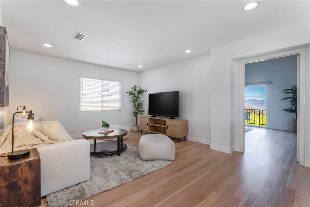 26413 Ocasey Place Stevenson Ranch, CA 91381 - Photo 31 of 75 a living room with furniture and a flat screen tv