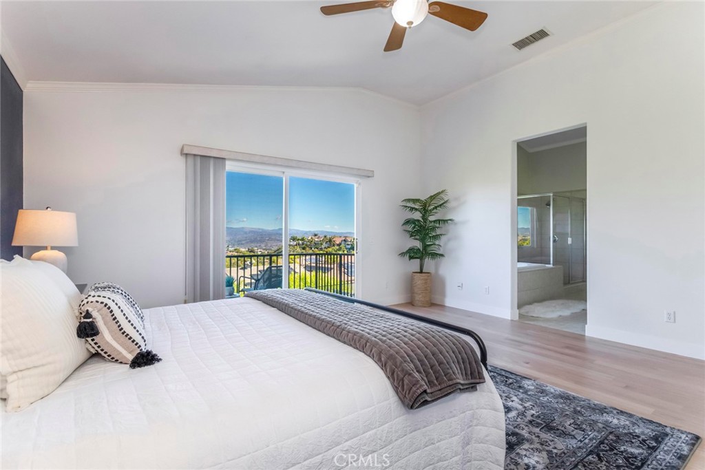 26413 Ocasey Place Stevenson Ranch, CA 91381 - Photo 35 of 75 a bedroom with a bed and a chandelier
