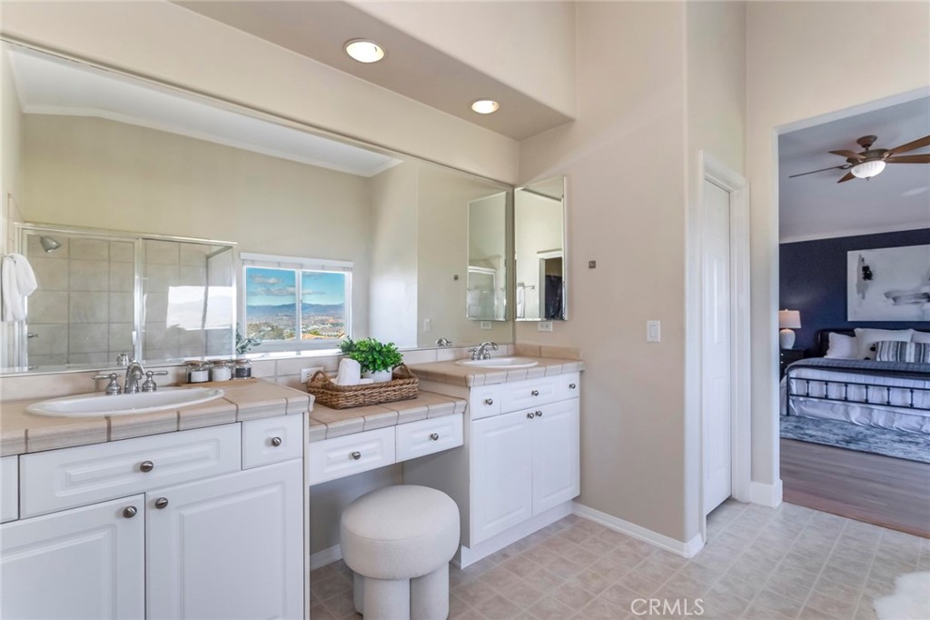 26413 Ocasey Place Stevenson Ranch, CA 91381 - Photo 37 of 75 a bathroom with a granite countertop sink mirror and toilet