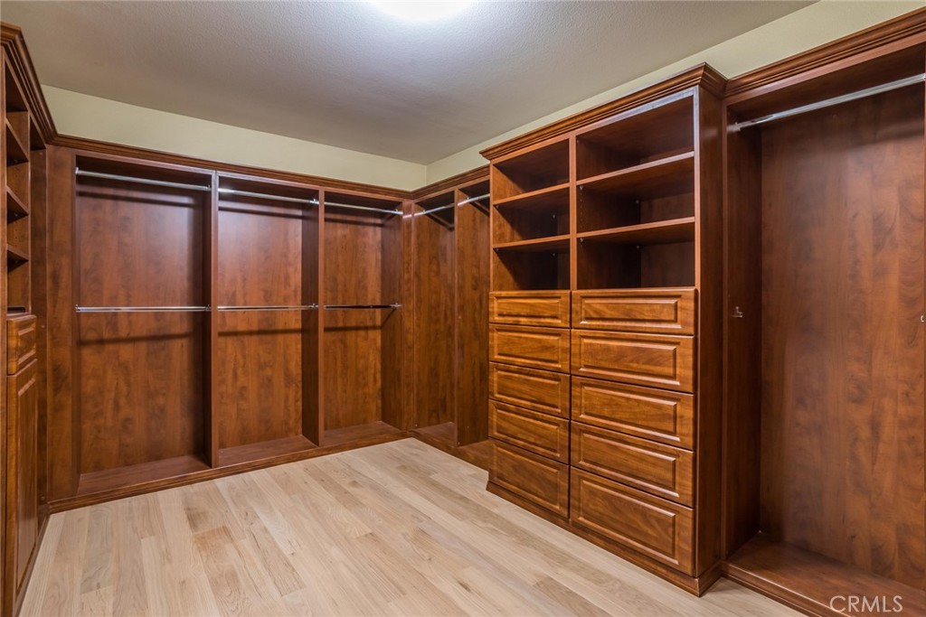 26413 Ocasey Place Stevenson Ranch, CA 91381 - Photo 40 of 75 a view of walk in closet with empty racks