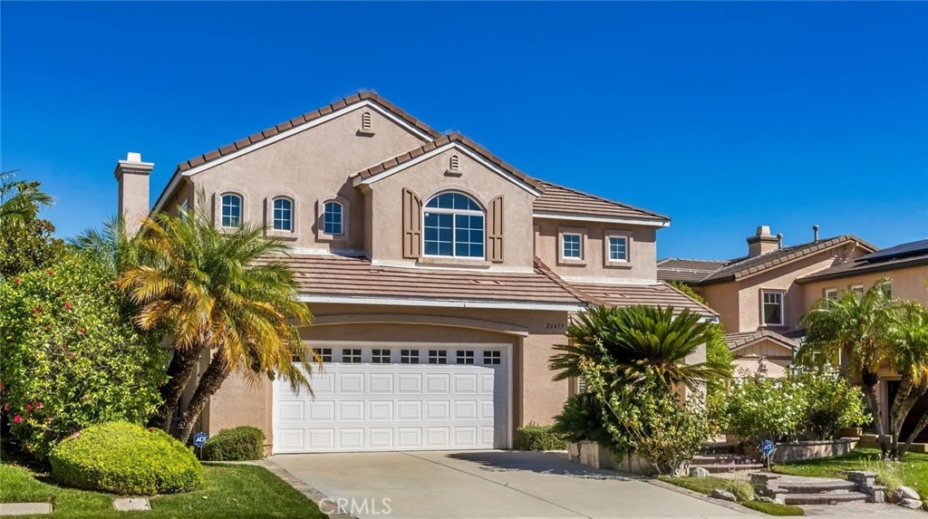 26413 Ocasey Place Stevenson Ranch, CA 91381 - Photo 4 of 75 a front view of a house with a yard and garage