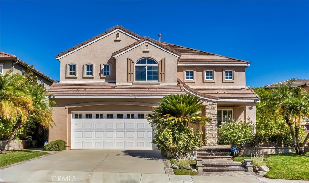 26413 Ocasey Place Stevenson Ranch, CA 91381 - Photo 5 of 75 a front view of a house with a yard