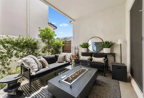 a living room with furniture a rug and a potted plant