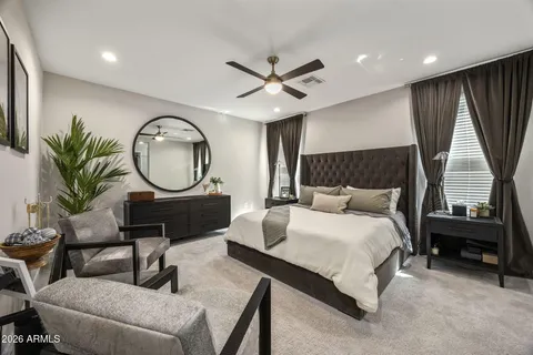 a living room with furniture a mirror and a large window