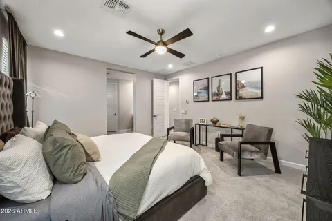a bed room with a bed and a chair