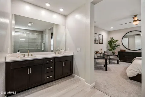 a spacious bathroom with a double vanity sink and a mirror