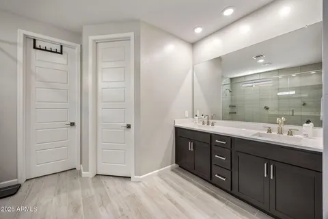 a bathroom with a double vanity sink and a mirror