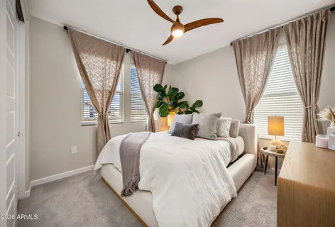 a bedroom with a bed couch and window