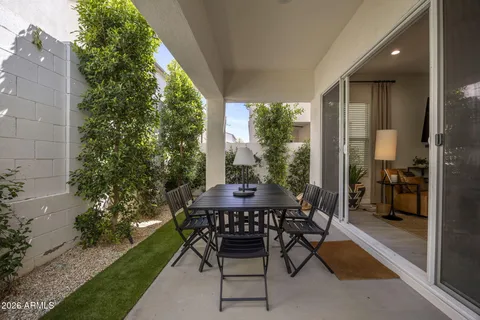 a patio with yard glass top table and chairs