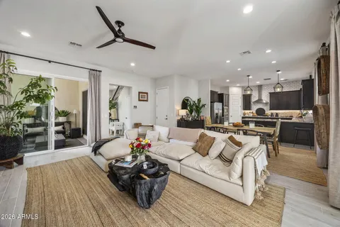 a living room with furniture and kitchen view