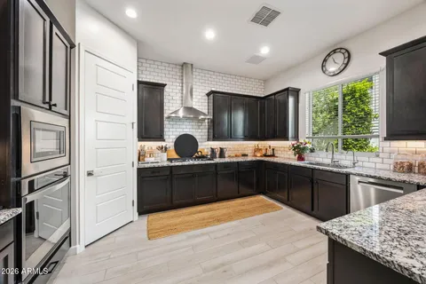 a kitchen with a sink stove and refrigerator