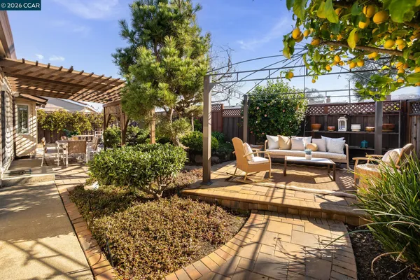 a view of a patio with couches table and chairs and potted plants