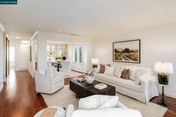a living room with furniture and a painting on the wall