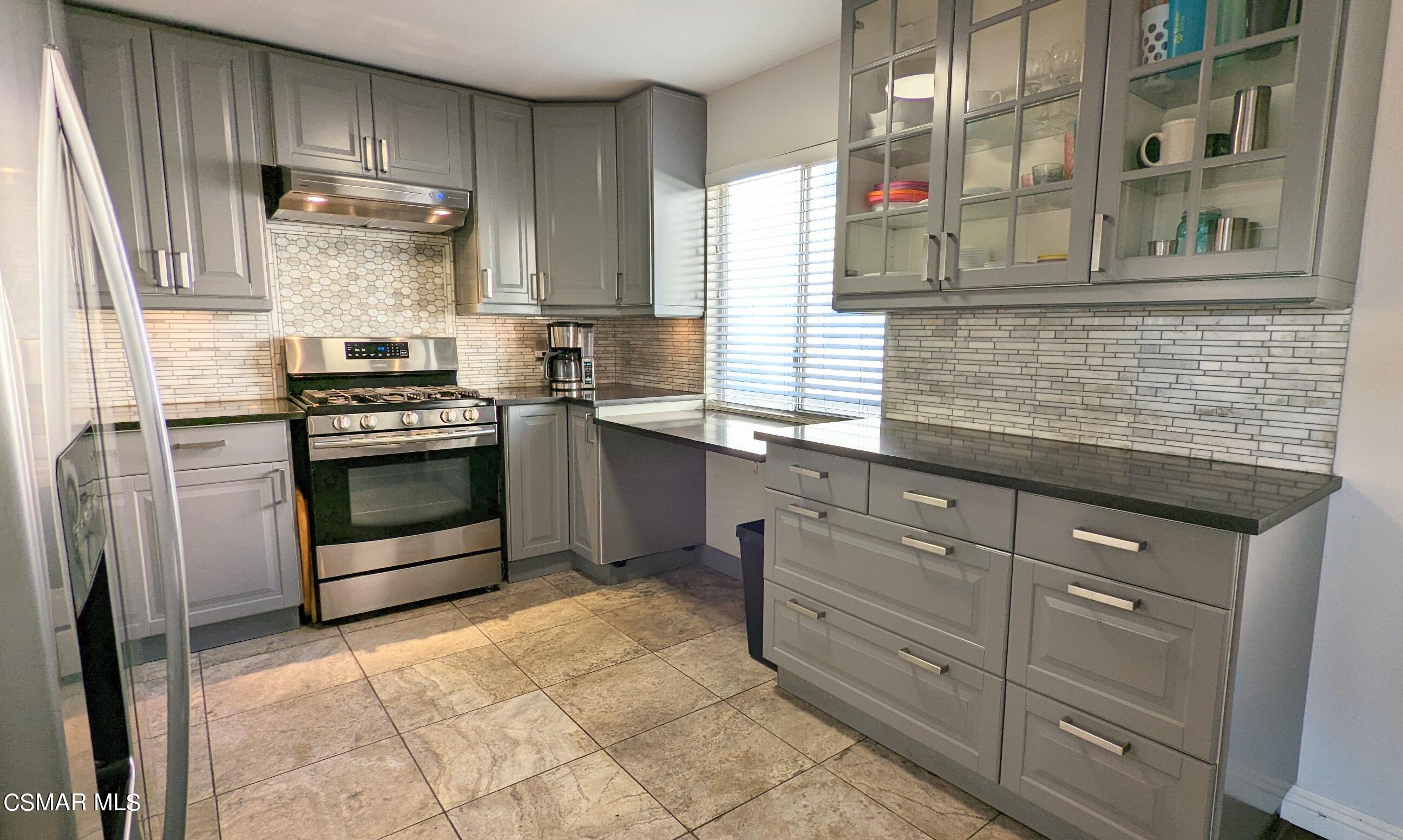 9758 Vía Roma Burbank, CA 91504 - Photo 5 of 8 a kitchen with stainless steel appliances granite countertop a stove and a sink