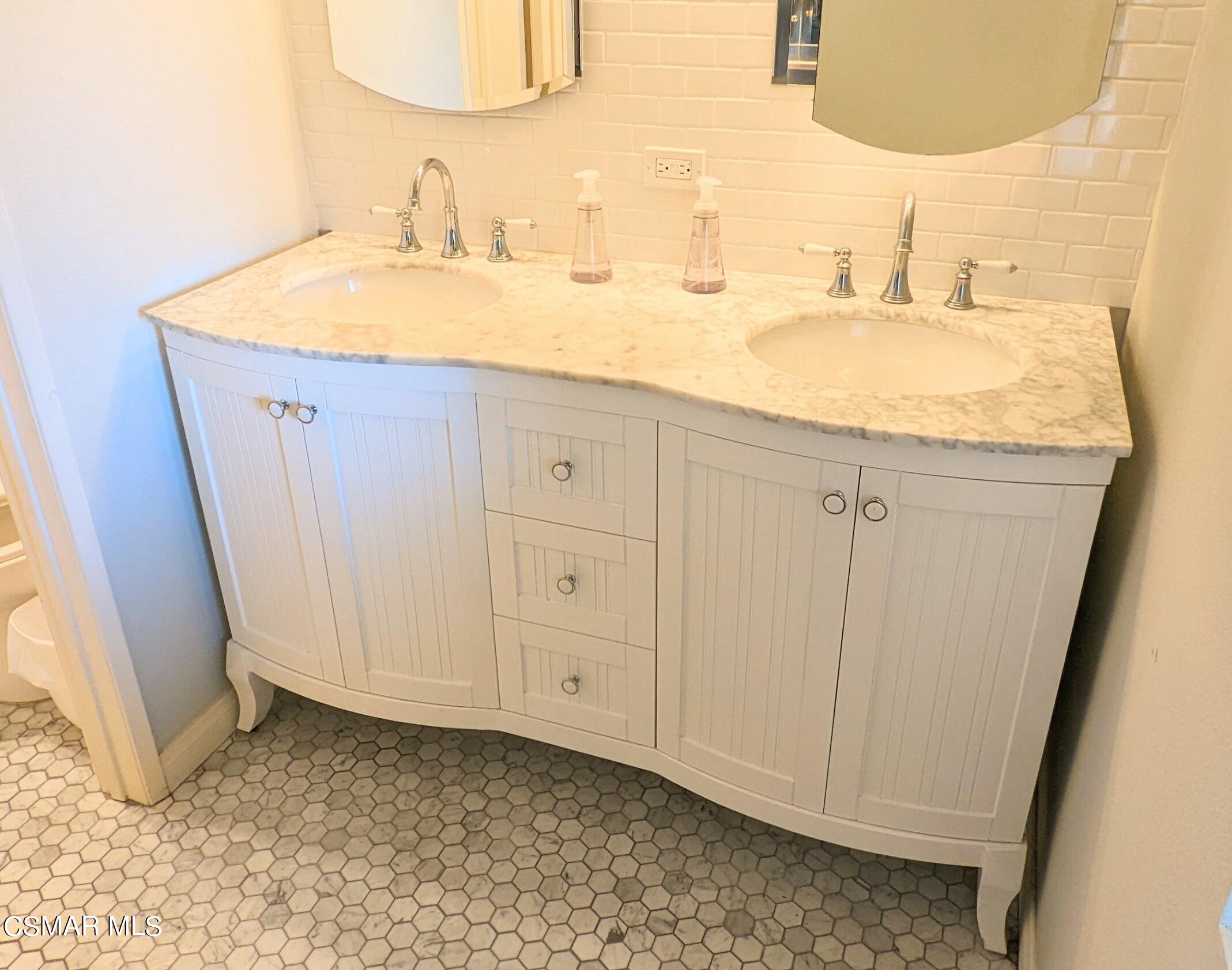 9758 Vía Roma Burbank, CA 91504 - Photo 6 of 8 a bathroom with a sink and a mirror