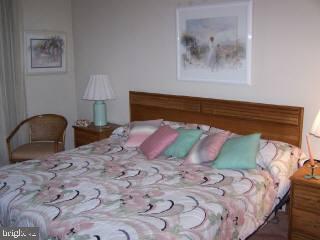 0 Edward Taylor Road, Unit 6 Ocean City, MD 21842 - Photo 3 of 6 a bedroom with a bed and a lamp on dresser