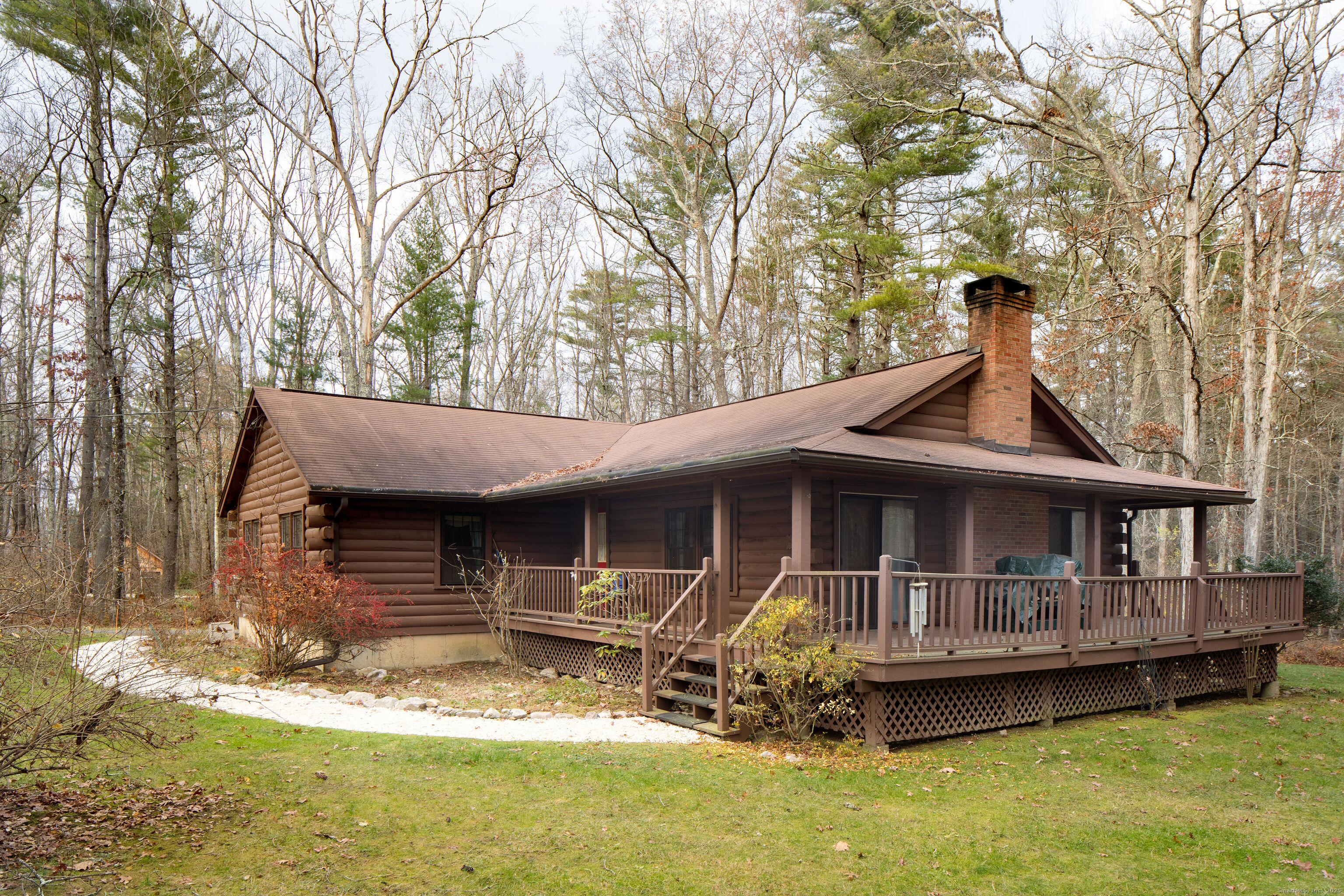 a backyard of a house with yard table and chairs