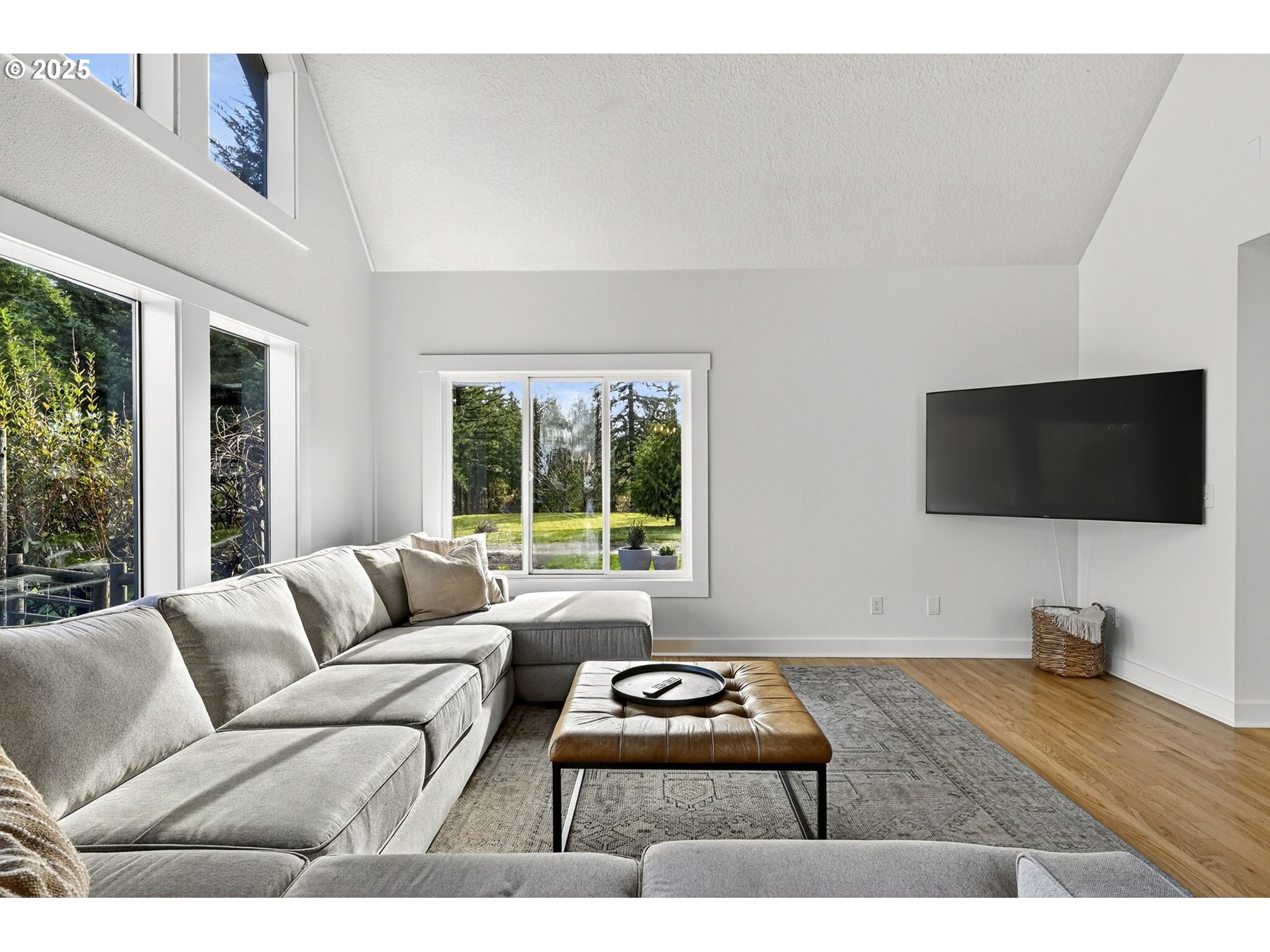 13162 Northwest McNamee Road Portland, OR 97231 - Photo 12 of 48 a living room with furniture and a flat screen tv