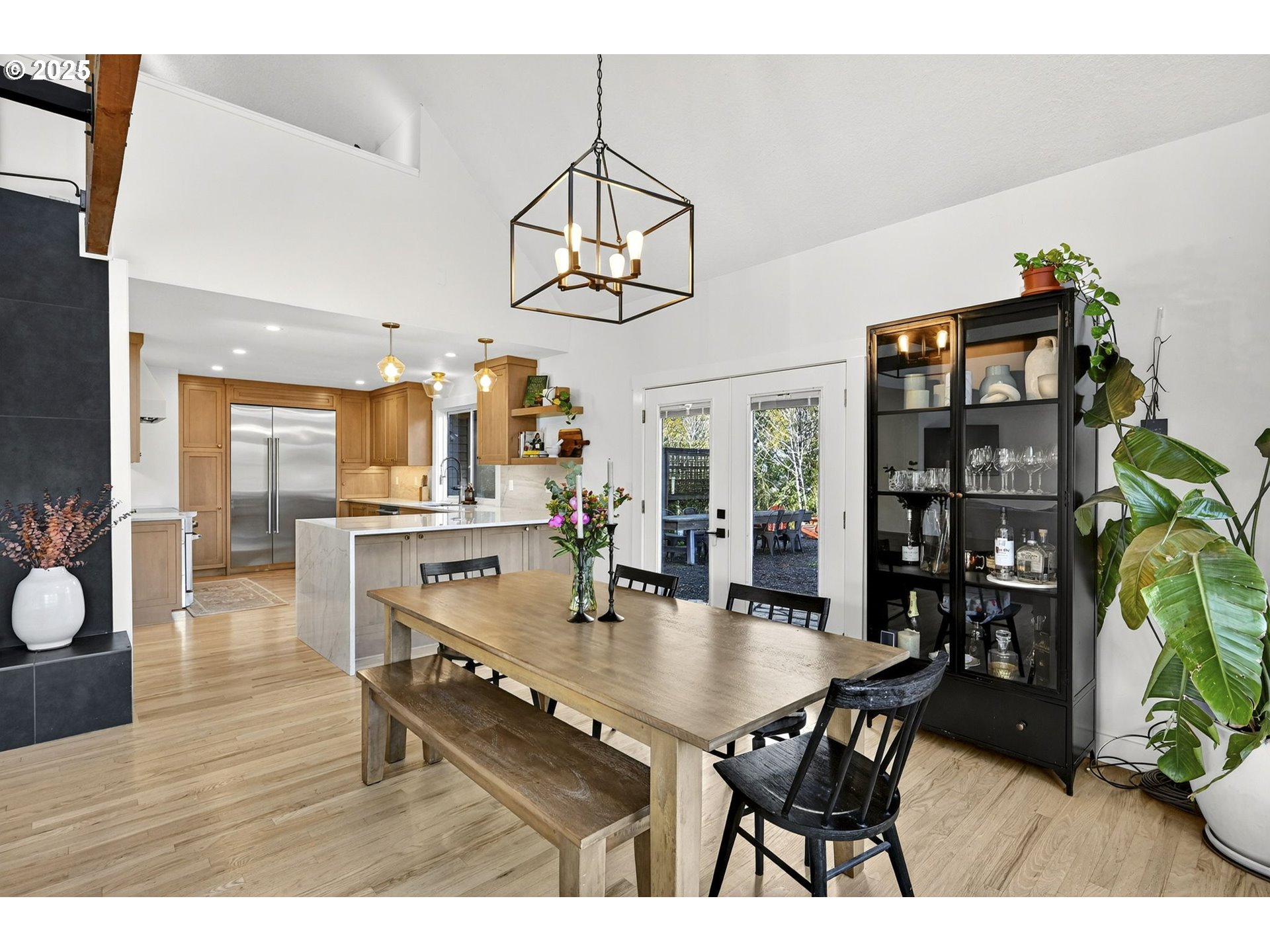 13162 Northwest McNamee Road Portland, OR 97231 - Photo 16 of 48 a dining room with wooden floor a chandelier a wooden table and chairs