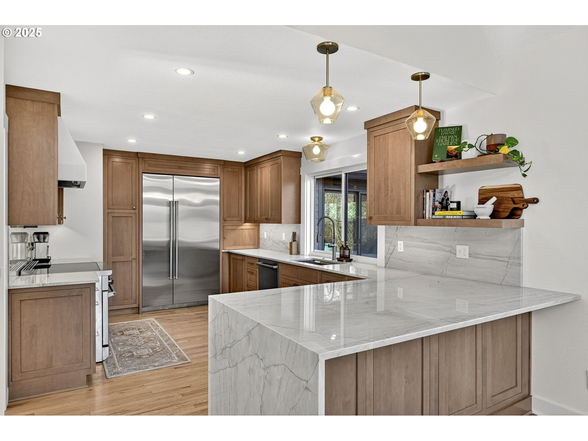 13162 Northwest McNamee Road Portland, OR 97231 - Photo 17 of 48 a kitchen with stainless steel appliances kitchen island granite countertop a sink cabinets and wooden floor