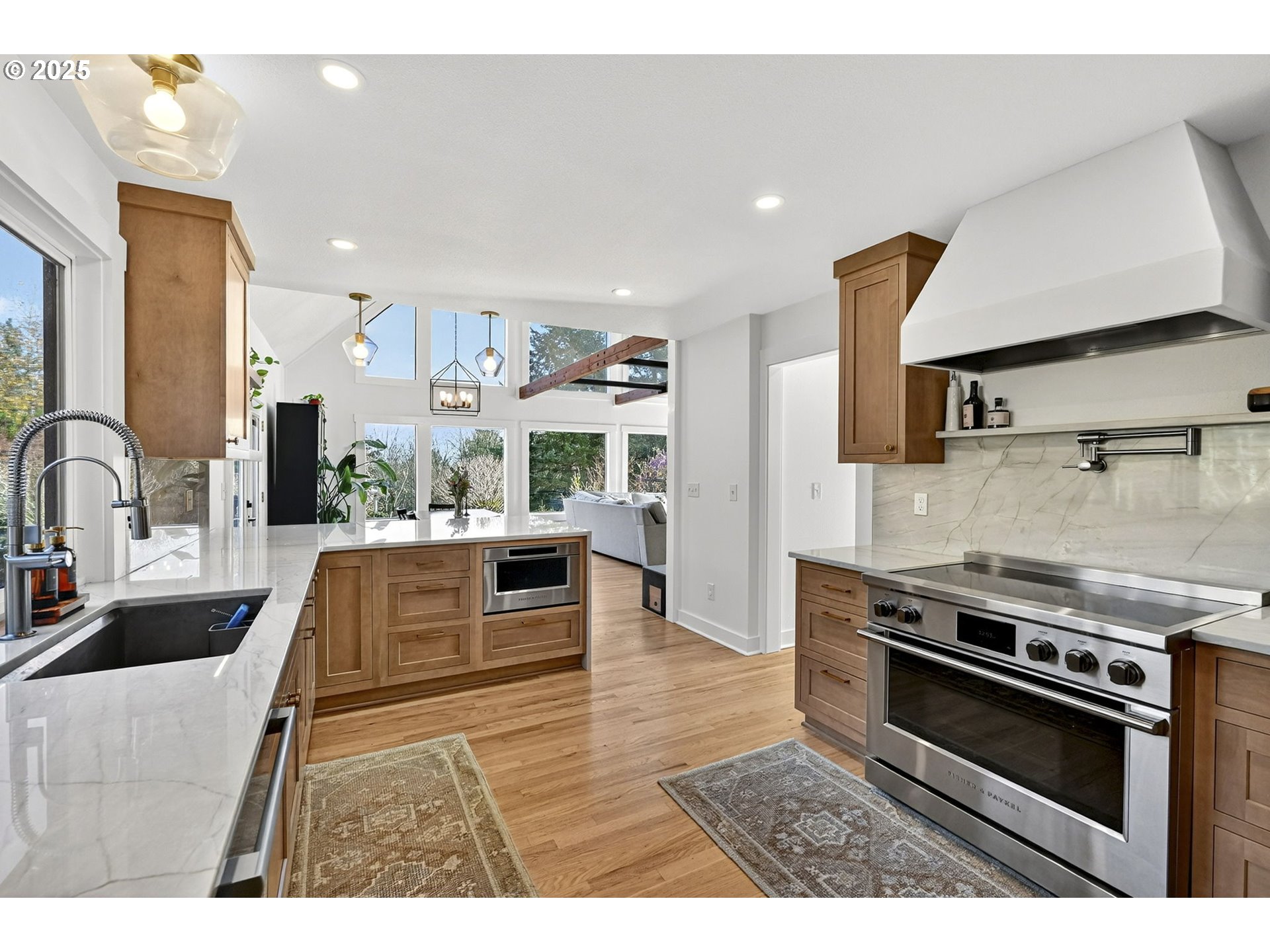 13162 Northwest McNamee Road Portland, OR 97231 - Photo 20 of 48 a kitchen with stainless steel appliances granite countertop a stove a sink and a microwave