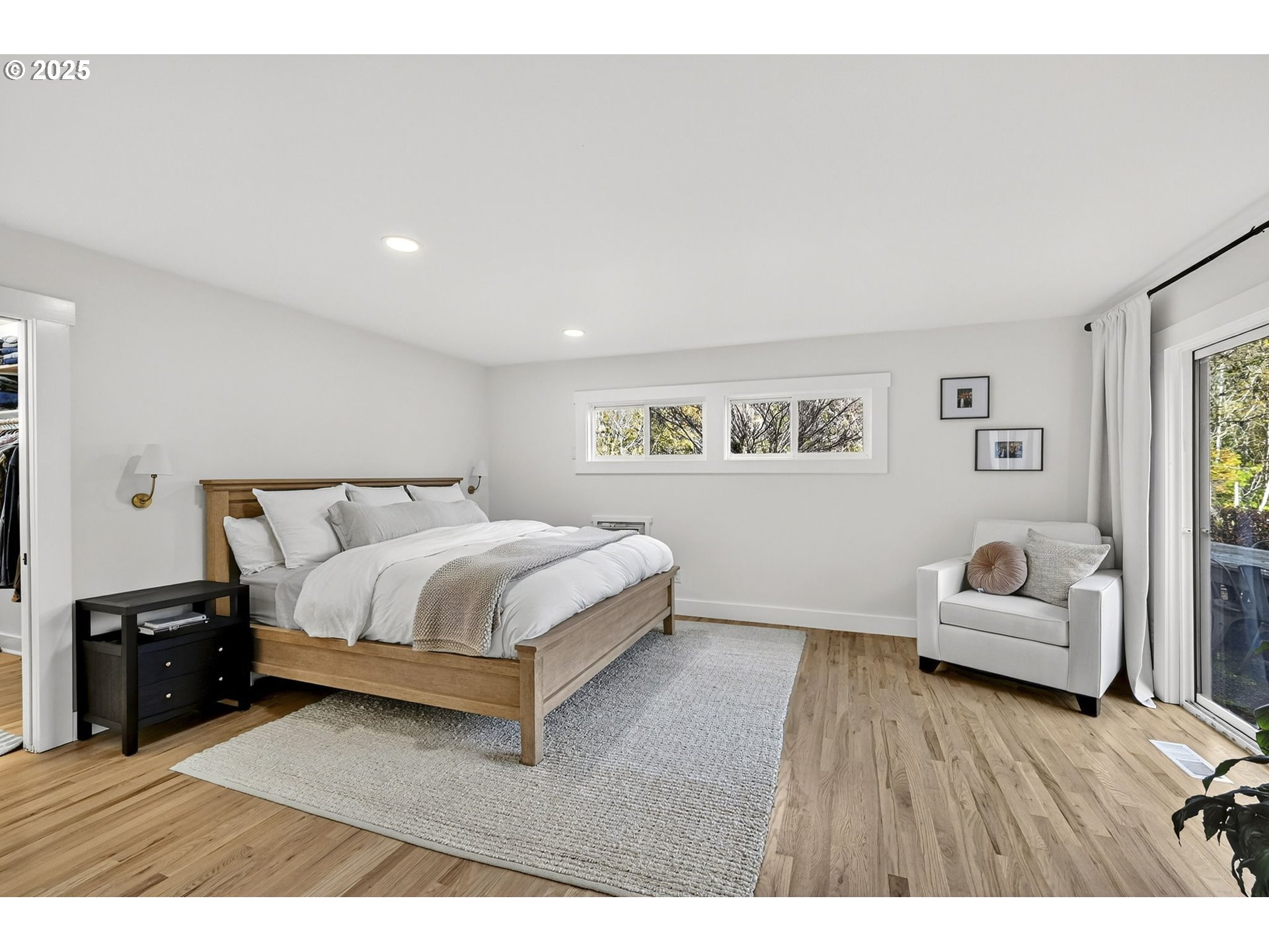 13162 Northwest McNamee Road Portland, OR 97231 - Photo 21 of 48 a spacious bedroom with a bed and wooden floor